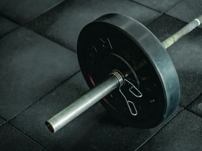 Professional weightlifting barbell on a gym floor background
